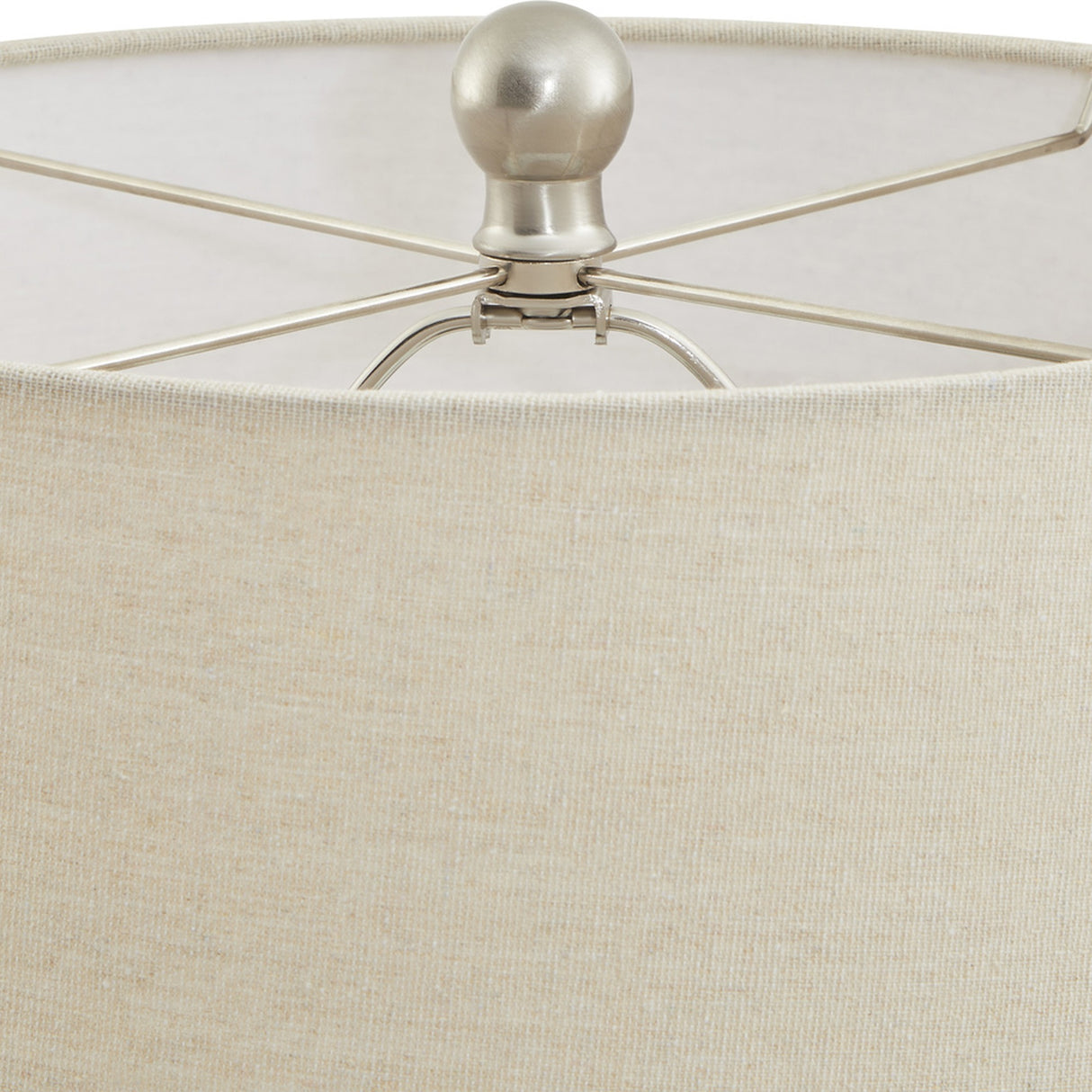 Close-up of the Hill Interiors Lattice Ceramic Table Lamp's natural linen drum shade and brushed nickel finial with spider fitting.