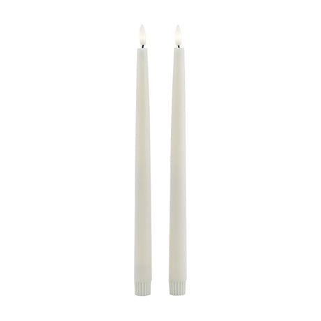 Hill Interiors set of two beige LED wax dinner candles, slim 25cm tapers with flickering flame tips, shown upright on a plain white background.
