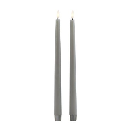 Hill Interiors set of two grey LED wax dinner candles, tall slim tapers with fluted bases and flickering flame tips, shown on a plain white background.