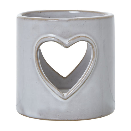 Hill Interiors white glazed ceramic tealight holder with a pierced heart cut-out on a cylindrical body, shown against a plain white background.