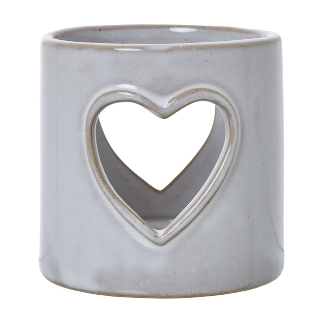Hill Interiors white glazed ceramic tealight holder with a pierced heart cut-out on a cylindrical body, shown against a plain white background.