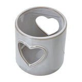 Hill Interiors white glazed ceramic tealight holder with pierced heart cut-out design, compact cylindrical form, shown on a plain white background.