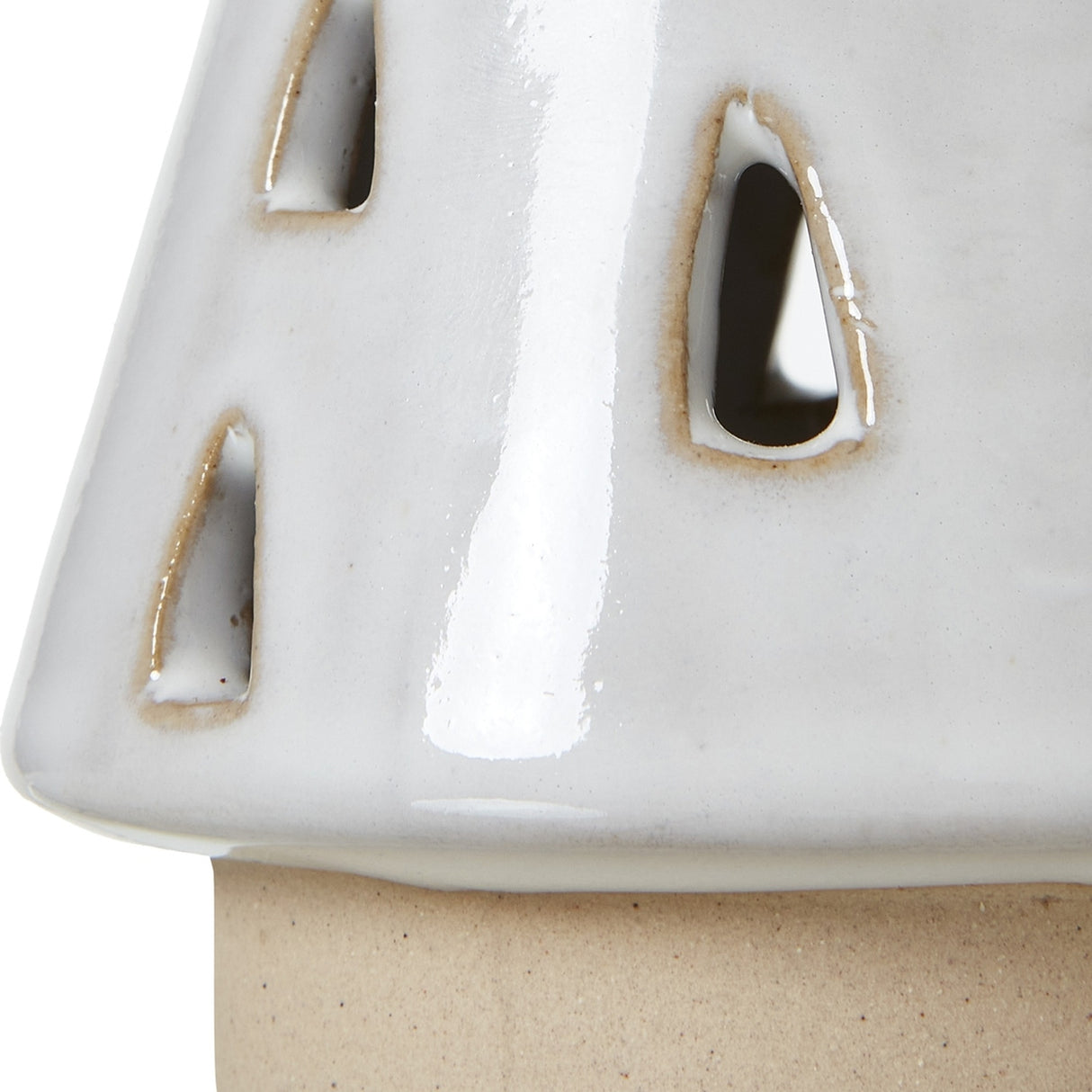 Close-up of Hill Interiors Small White Ceramic Cut-Out Tree with teardrop openings and glossy white glaze over an unglazed base.