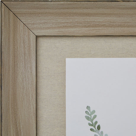 Close-up of the Hill Interiors Delicate Fern Print corner, showing the washed pale brown wood frame, linen-style mount and soft green fern detail.