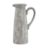 Hill Interiors Tall Ceramic Jug in white with a distressed glaze, slender tapered body, shaped pouring lip and looped handle, on a plain background.