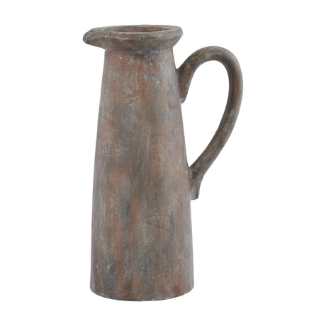 Hill Interiors Tall Ceramic Jug in brown with a tapered body, pouring lip and curved handle, showing a weathered glazed finish on a white background.