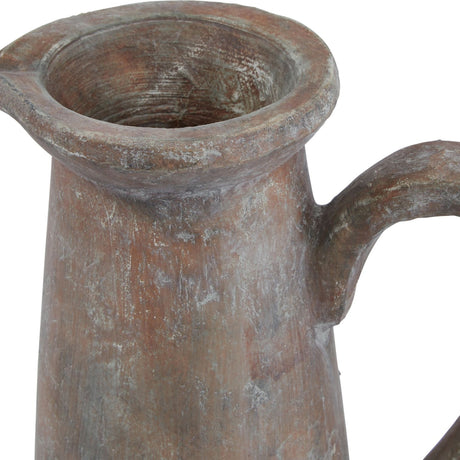 Close-up of Hill Interiors Tall Ceramic Jug in brown, showing the pouring lip, curved handle and weathered glazed stoneware finish against a white background.