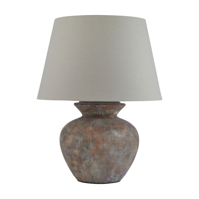 Hill Interiors Lumbriden round ceramic table lamp with weathered brown glazed base and tapered natural linen shade, shown on a plain white background.