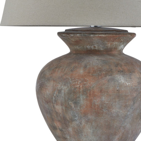Close-up of the Hill Interiors Lumbriden round ceramic table lamp base in weathered brown, topped with a natural linen shade against a white background.