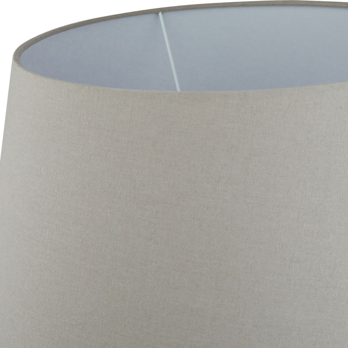 Close-up of the Hill Interiors Lumbriden table lamp's natural linen drum shade, showing its woven texture and white interior lining.