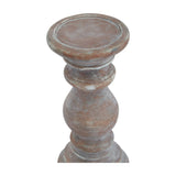 Hill Interiors small brown ceramic column candle holder shown close up, highlighting the turned baluster shape and warm, tactile earthy finish.