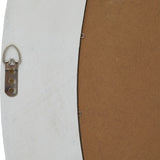 Close-up of the Hill Interiors Washed Wood Round Framed Large Mirror in white, showing the D-ring hanger and metal clips securing the brown backing board.