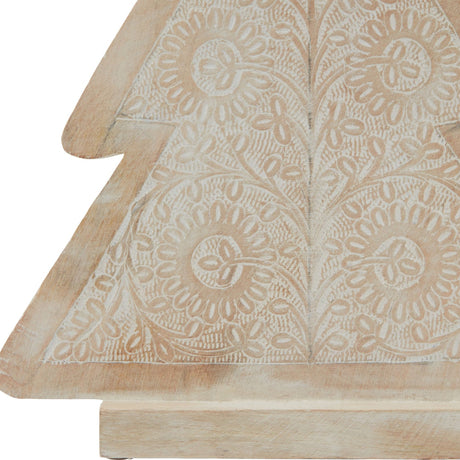 Close-up of Hill Interiors Large Patterned Wooden Decorative Tree in brown, showing carved floral cut-out detail and whitewashed grain over warm wood.