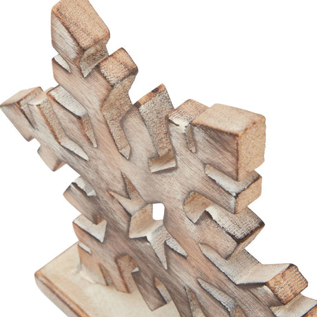 Close-up of Hill Interiors White Wash Wooden Snowflake Decoration showing carved wood points with brown tones beneath a brushed pale finish.