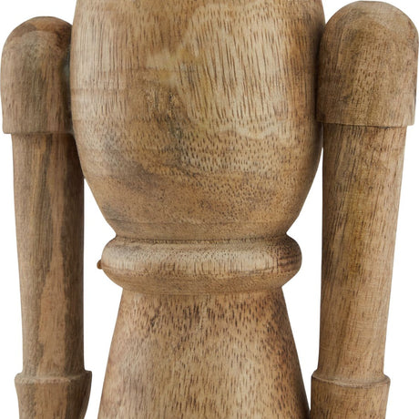Close-up of Hill Interiors Wooden Nutcracker Decoration in beige, showing the carved solid wood body and arms with visible natural grain.