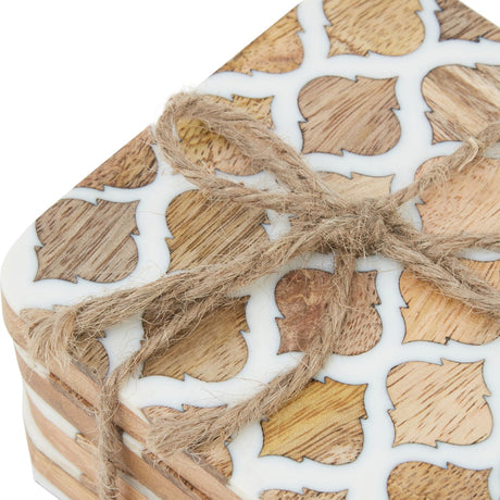 Close-up of Hill Interiors Set of 4 Wood Effect Geometric Coasters in white, tied with jute twine, showing the wood surface and white geometric pattern.