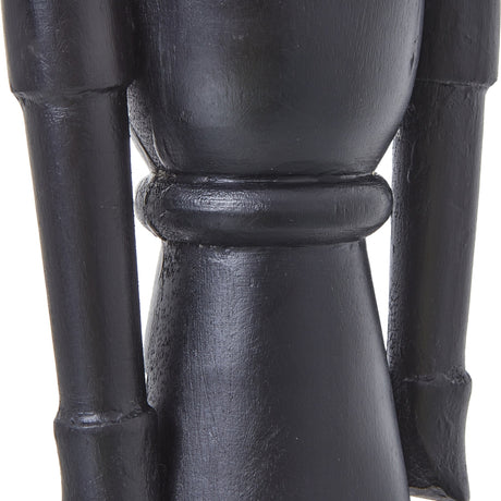 Close-up of the Hill Interiors Minimalist Wooden Nutcracker Decoration in black, showing the smooth matte torso, banded waist detail and slim arms.