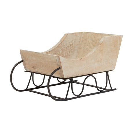 Hill Interiors wooden decorative sleigh with white wash finish over warm brown grain, set on a black metal runner base against a plain white background.