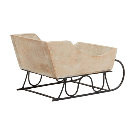 Hill Interiors wooden decorative sleigh with white wash finish over warm brown tones, set on a curved black metal runner base against a white background.