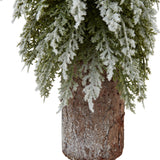 Close-up of Hill Interiors Small Snowy Fir Tree on Tall Wood Log, showing frosted green branches above a brown wood-grain plastic log base.