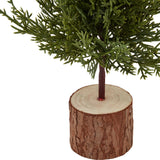 Close-up of Hill Interiors Small Green Fir Tree base, showing the plastic green foliage set into a natural wood log stand on a white background.