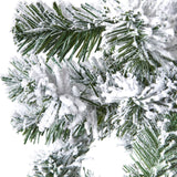 Close-up of Hill Interiors Extra Large Snowy Spruce Tree showing deep green plastic needles heavily dusted with white flocking against a plain background.