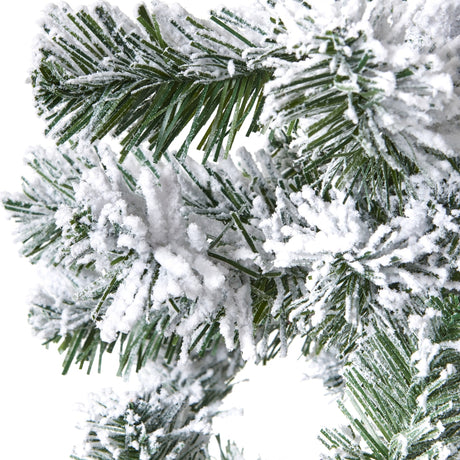 Close-up of Hill Interiors Extra Large Snowy Spruce Tree showing deep green plastic needles heavily dusted with white flocking against a plain background.