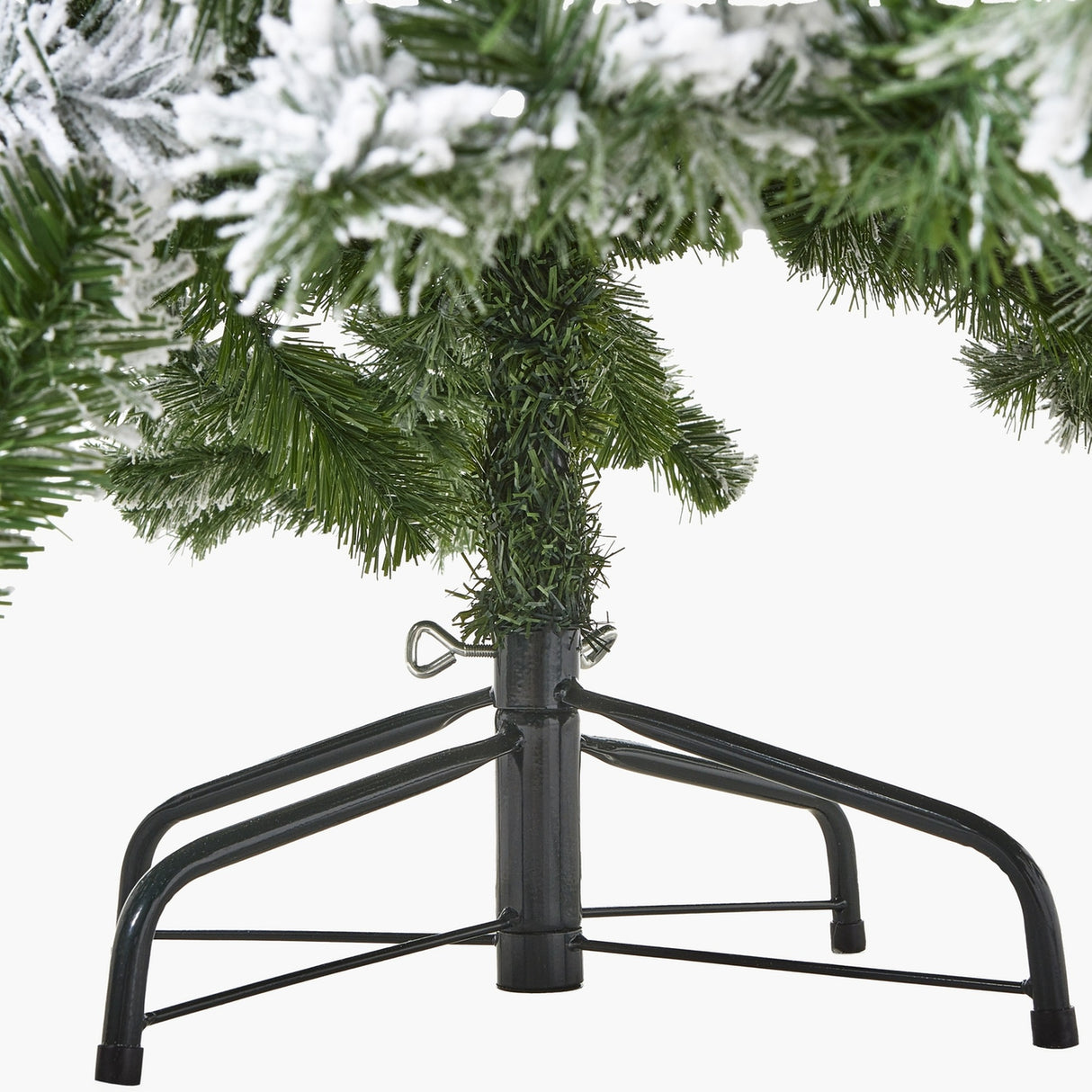 Close-up of the black metal folding stand and lower snow-dusted branches of the Hill Interiors Extra Large Snowy Spruce Tree on a white background.