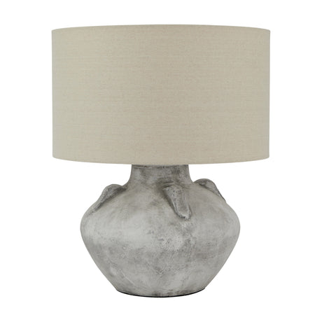 Elvessa stone lekanis ceramic table lamp by Hill Interiors with rounded beige base and neutral linen drum shade on a plain background.