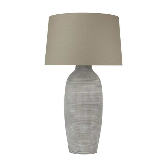Hill Interiors Elvessa table lamp with a tall ridged grey-beige ceramic urn base and a tapered oatmeal linen drum shade, on a white background.
