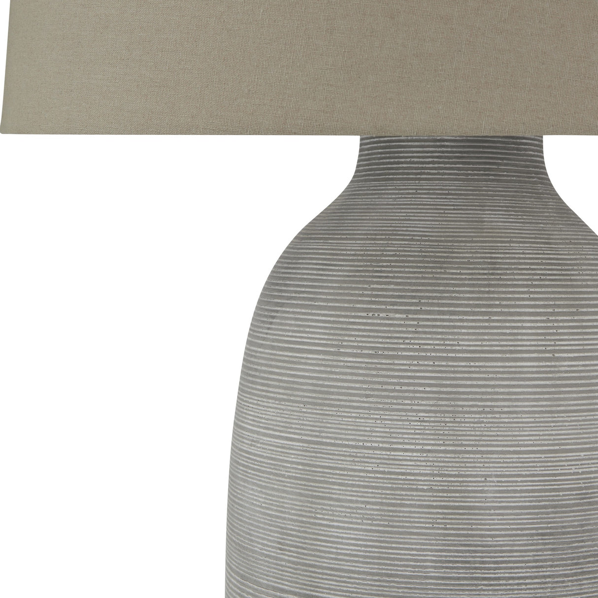 Close-up of the Hill Interiors Elvessa ceramic table lamp base, showing its ribbed grey stone-effect texture and beige linen shade edge.