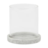 Hill Interiors Stone Hurricane Lantern in beige, featuring a clear glass cylinder set on a round stone-effect ceramic base, shown on a white background.