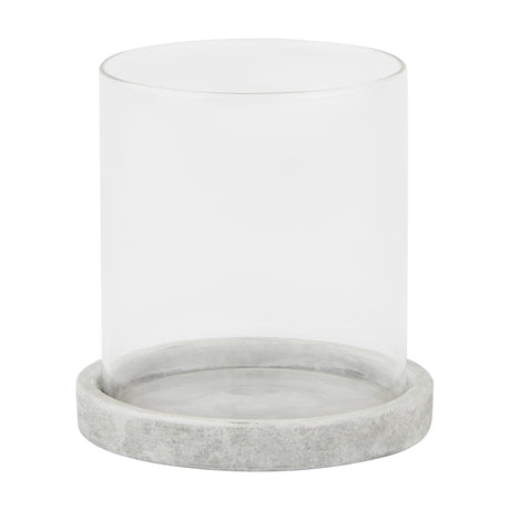 Hill Interiors Stone Hurricane Lantern in beige, featuring a clear glass cylinder set on a round stone-effect ceramic base, shown on a white background.