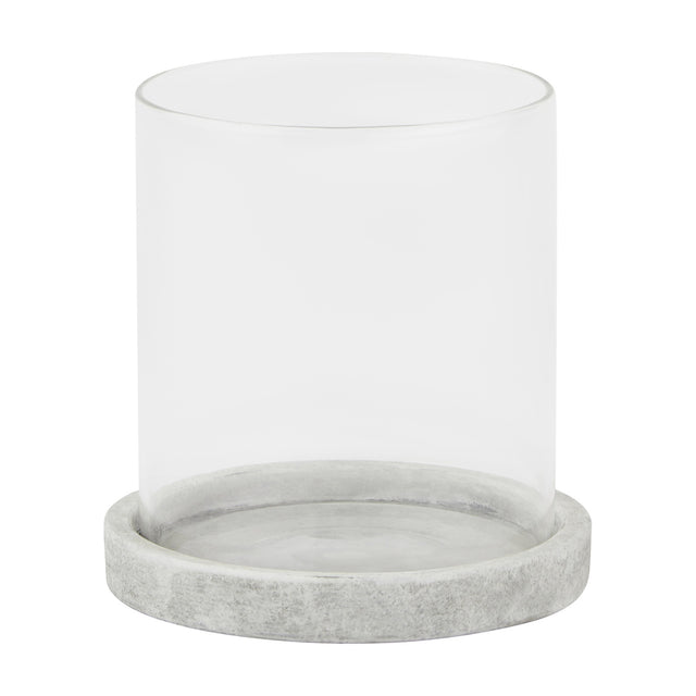 Hill Interiors Stone Hurricane Lantern in beige, featuring a clear glass cylinder set on a round stone-effect ceramic base, shown on a white background.