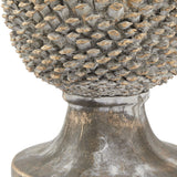 Close-up of Hill Interiors large ceramic pinecone ornament showing textured scales in beige stone effect finish with gold-tipped accents above a smooth base.