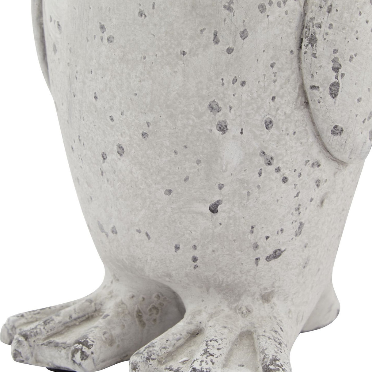 Close-up of the Hill Interiors Small Stone Effect Penguin Statue in beige, showing the textured ceramic body and feet with a weathered speckled finish.