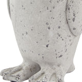 Close-up of the Hill Interiors Small Stone Effect Penguin Statue in beige, showing the textured ceramic body and feet with a weathered speckled finish.