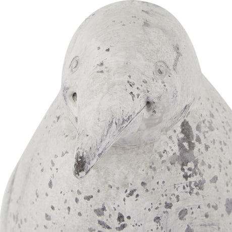 Close-up of the Hill Interiors Grey Stone Effect Penguin Statue with moulded ceramic head, slender beak, and weathered beige-grey finish on white.