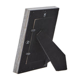 Rear view of the Hill Interiors Grey Washed Wooden Photo Frame showing the black backing board, hanging hooks and fold-out easel stand on a white background.