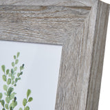 Close-up of the Hill Interiors Grey Washed Wooden Photo Frame corner, showing the flat wood moulding with visible grain and a botanical print inside.