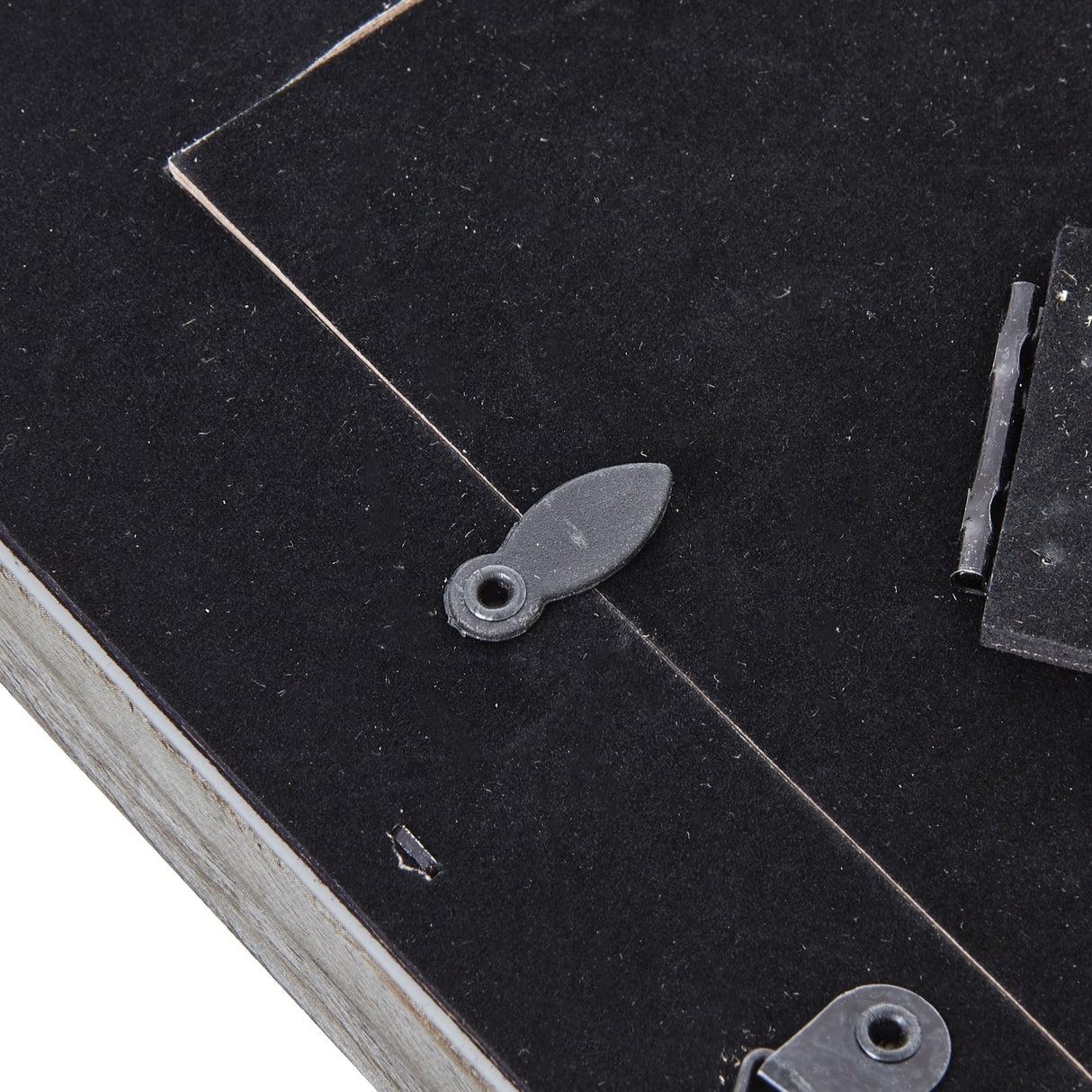 Close-up of the Hill Interiors Grey Washed Wooden Photo Frame reverse showing black backing board, rotating tab fastener and hinged stand.