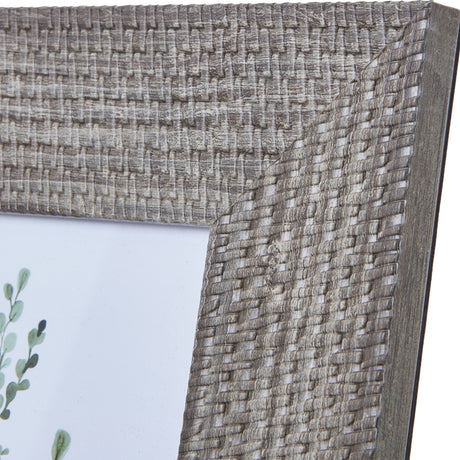 Close-up of the Hill Interiors Woven Photo Frame in grey, showing the textured woven wooden surface at the corner with a hint of botanical print inside.