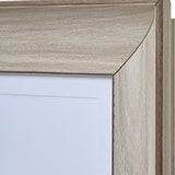 Close-up of the top corner of the Hill Interiors White Washed A3 Wooden Photo Frame, showing the pale white washed wood grain and mitred joint.