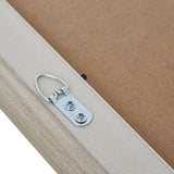 Close-up of the Hill Interiors White Washed Wooden A2 Picture Frame corner showing the metal D-ring hanger screwed to the pale wood backing.