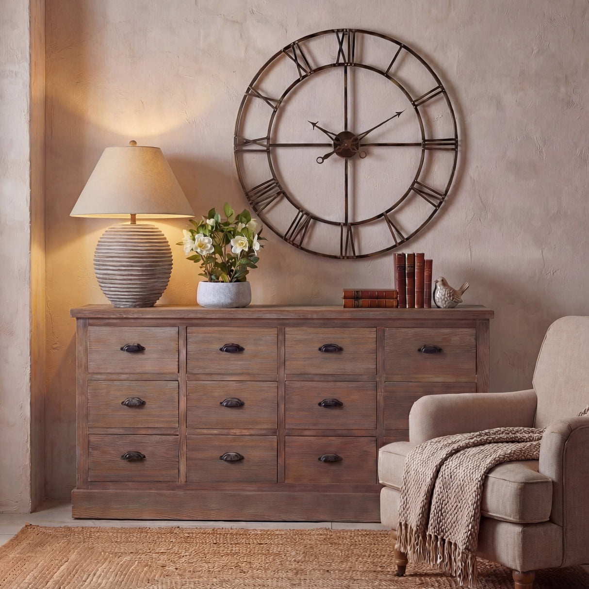 Hill Interiors ceramic table lamp with ribbed brown base and natural linen shade, lit on a rustic wooden dresser beside books and a large wall clock.
