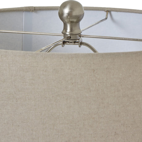 Close-up of Hill Interiors White Beaded Ceramic Table Lamp showing the brushed nickel finial and harp above the natural linen drum shade.