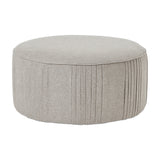 Hill Interiors Swivel Ottoman in oatmeal twill, a large round cream upholstered stool with pleated side detailing, shown on a plain white background.