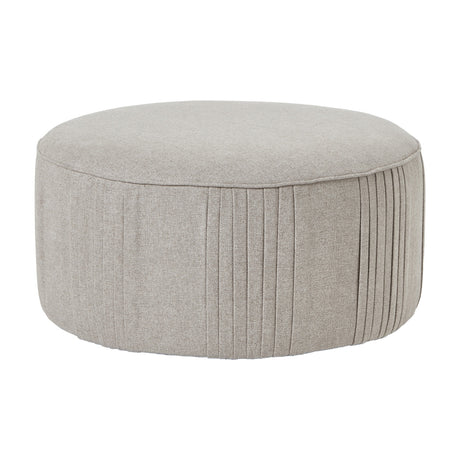 Hill Interiors Swivel Ottoman in oatmeal twill, a large round cream upholstered stool with pleated side detailing, shown on a plain white background.
