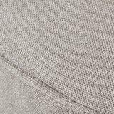 Close-up of the Hill Interiors Swivel Ottoman's oatmeal twill upholstery, showing the woven cream fabric texture and a seam detail.