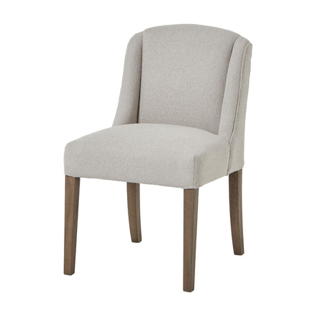 Hill Interiors Braxdon Aspen dining chair in cream bouclé upholstery with curved wingback and tapered wooden legs, on a plain white background.